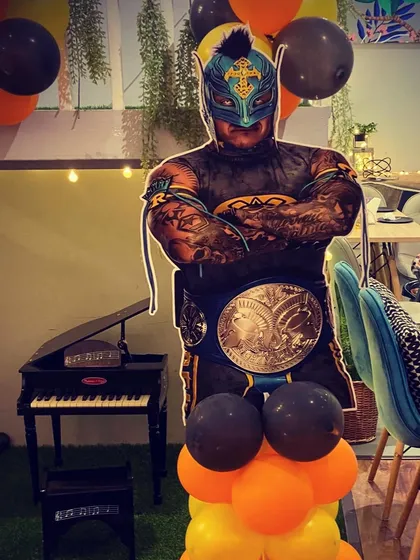 A life-sized cutout of WWE wrestler Rey Mysterio adds to the excitement of a wrestling-themed party.