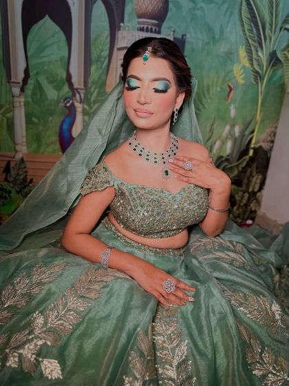 A stunning mint green bridal or reception look. The eye makeup is a beautiful blend of green and silver, creating a cool, ethereal vibe.