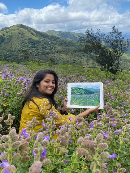 Me with my painting in the middle of the beautiful purple-blue flowers. It's a joy to combine my love for nature and art.
