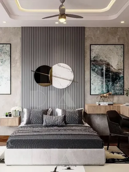 A grey fluted panel serves as a dramatic accent wall behind the bed in this modern bedroom. The design is balanced with a floating wooden desk and nightstand, creating a functional and stylish space.