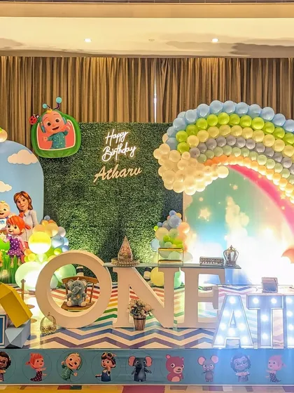 Here is a complete Cocomelon themed stage for a first birthday. I use character cutouts, a rainbow balloon arch, and marquee letters to bring the popular show to life.