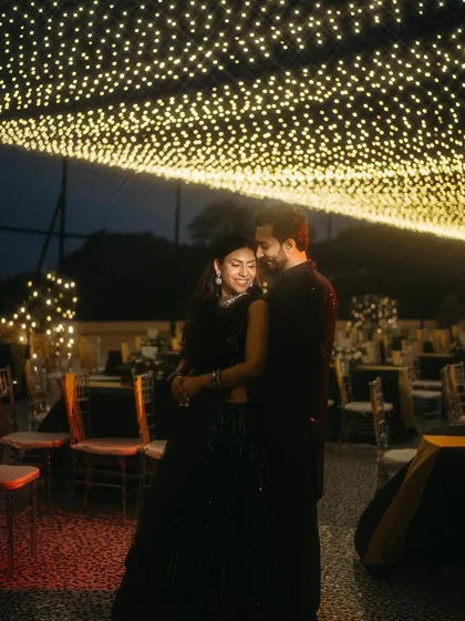 A romantic embrace under a ceiling of countless fairy lights, creating a truly magical sangeet night atmosphere.