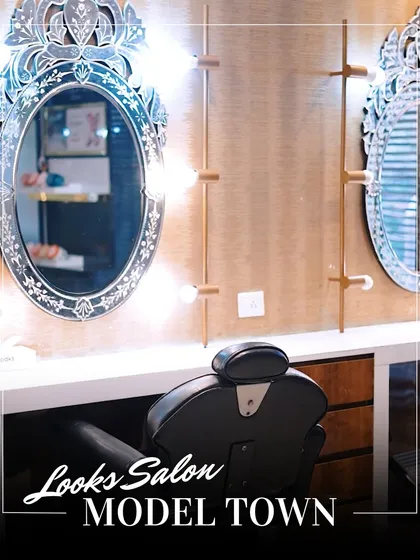 A shot of our elegant styling stations, complete with ornate mirrors and professional lighting, where the magic happens.