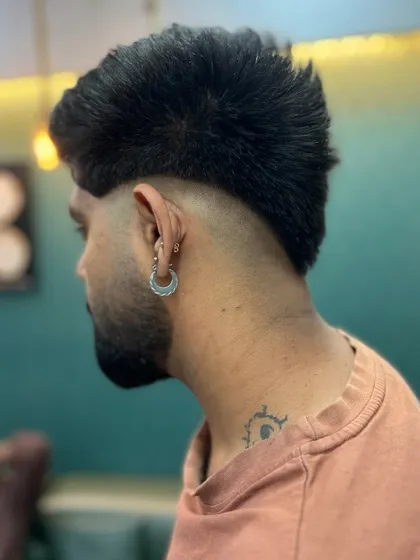 The back view of this edgy mullet shows the distinct separation between the faded sides and the textured length at the nape. This style is all about strong lines and attitude.