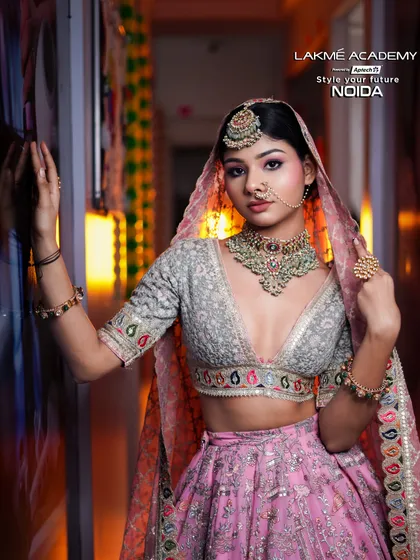 A contemporary bride in a pastel pink lehenga. This look is perfect for a daytime wedding, featuring soft makeup and elegant jewelry, a style we cover extensively in our courses.