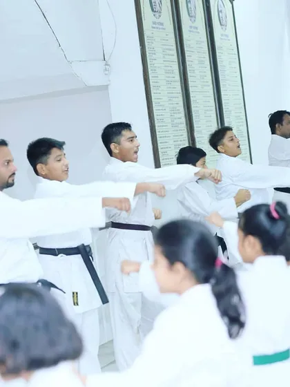 My guru leading a class of teenage students, ensuring each one executes their punch with the correct form and power. Attention to detail is key in our training.