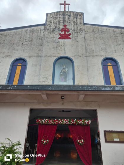 Simple entrance decoration for a church event. The red drapes and floral arrangements add a touch of celebration to the venue.