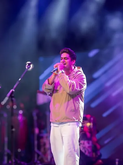 A key part of concert photography is capturing the artist's presence. Here is singer Amit Prakash Mishra performing under the dynamic stage lights at FLAME University.