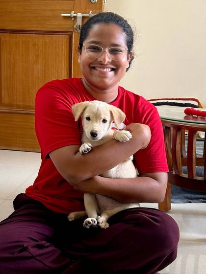 A sweet, gentle hug with a small puppy. These early moments of positive handling and affection are so important for building a dog's confidence and trust in people for the rest of their life.