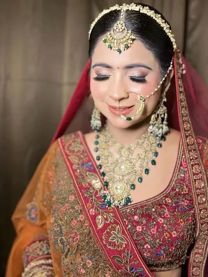 A serene portrait of the bride, with her eyes closed, showcasing her flawless makeup and the intricate details of her jewellery.