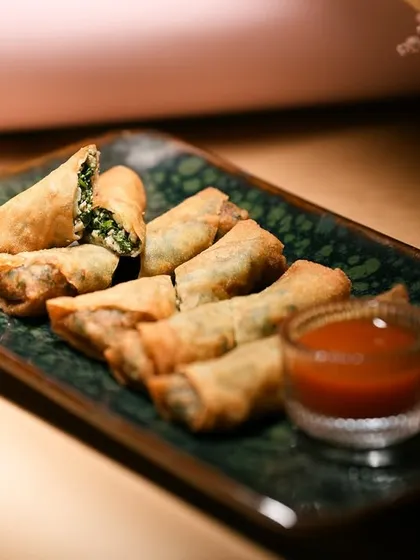 My Chicken & Spinach Cheese Cigars are crispy, cheesy, and absolutely irresistible. Here they are served with a dipping sauce, ready for a delicious gathering.