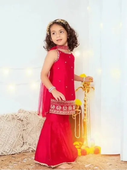 A beautiful portrait for Navratri. This little girl is dressed in a stunning traditional red outfit, ready for the festive celebrations.