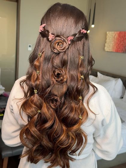 A close-up of the intricate rose-braid hairstyle created for this pre-wedding look. It's a romantic and beautiful detail.