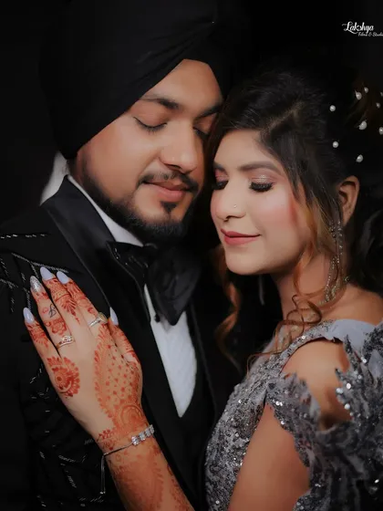 A close up portrait showing the couple's serene and happy expressions. The details of the bride's henna and the groom's tuxedo are beautifully captured.