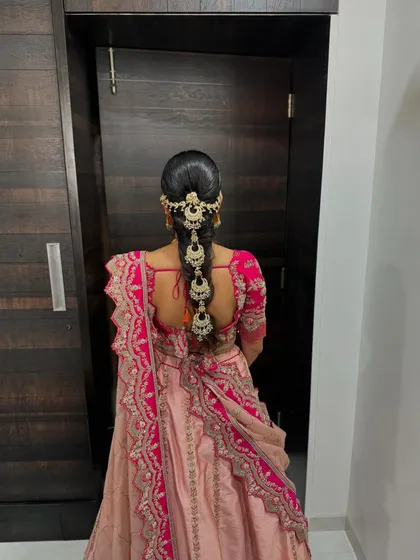 A traditional bridal braid, adorned with stunning, elaborate hair jewelry.