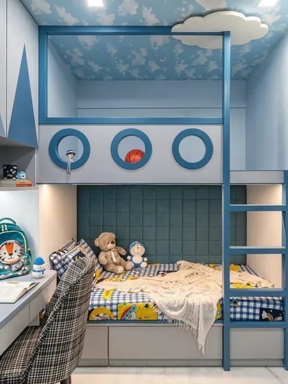 A closer look at the custom-built bunk bed, designed to feel like a ship's cabin. The lower bunk features a comfortable upholstered headboard, while the upper bunk includes a fun cloud detail and a sturdy ladder for access.
