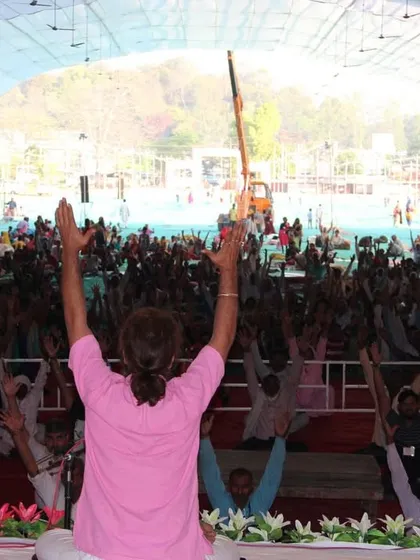 Leading a large gathering in a yoga session. My aim is not to promise happiness after death, but to provide tools and techniques so that people can live a life free from unnecessary suffering right now.
