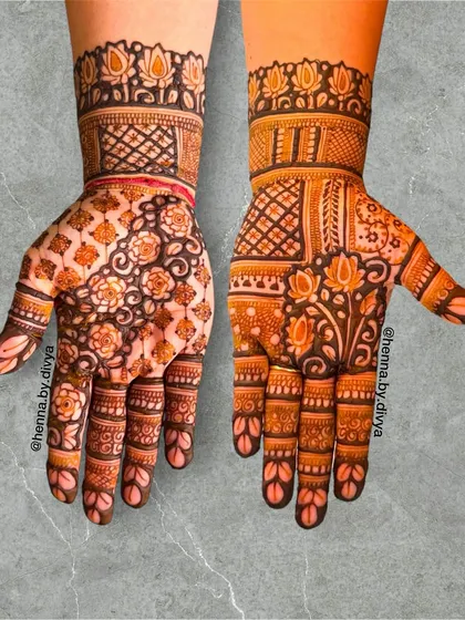 This design combines a floral grid pattern on one hand with a more open floral and lotus design on the other. It's a beautiful example of modern Indian mehendi.