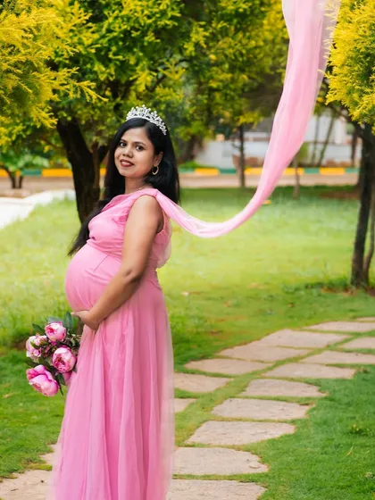 This is your fairytale moment. For this outdoor maternity session, we used a beautiful pink gown and flowing fabric to create a dreamy, ethereal portrait that celebrates the magic of motherhood.