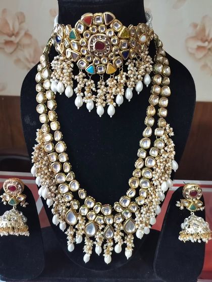 A Navratna-style Kundan choker paired with a long Polki rani haar, a vibrant choice for a festive look.