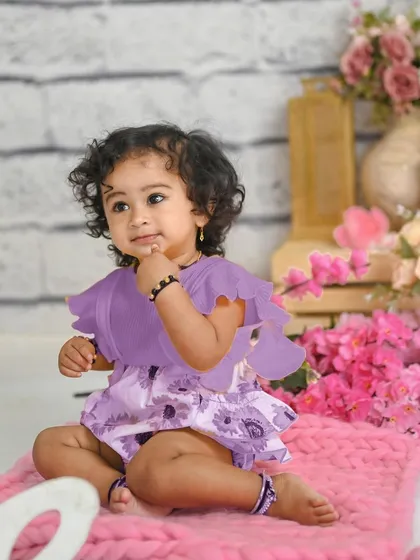 This sweet girl is celebrating her first birthday with a lovely pink and purple floral theme. Sitter sessions are perfect for capturing their curious expressions.
