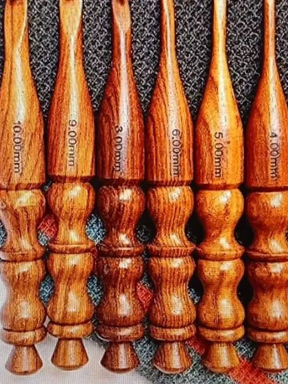 I offer a range of classic, fully wooden crochet hooks. They are polished for a smooth glide and carved to fit comfortably in your hand, with the size clearly marked on each one.