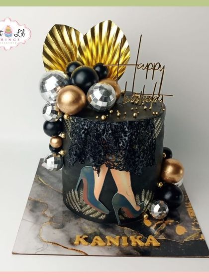 Stepping into elegance with this glamorous black and gold birthday cake for Kanika. The design features a disco ball, high heels, and a sophisticated marble-effect board.