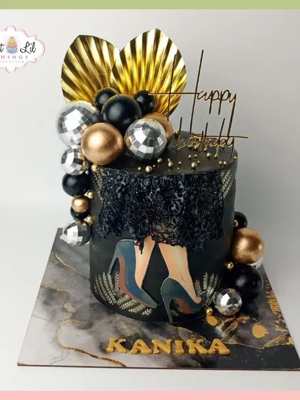 Stepping into elegance with this glamorous black and gold birthday cake for Kanika. The design features a disco ball, high heels, and a sophisticated marble-effect board.