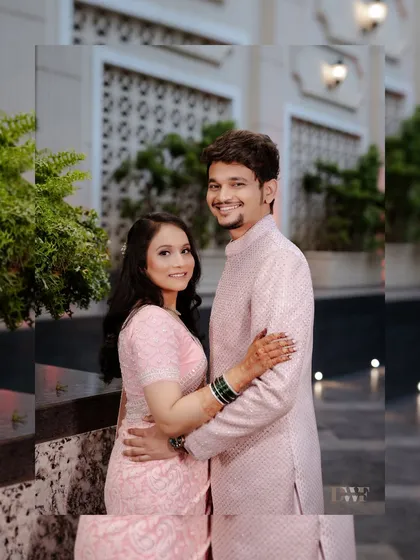 A classic portrait of the engaged couple. Their happy smiles and comfortable embrace show their deep affection for one another.