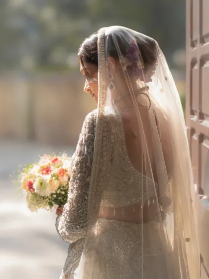 A timeless bridal portrait with soft, natural light. The way the light catches the veil creates a beautiful, ethereal glow around the bride.
