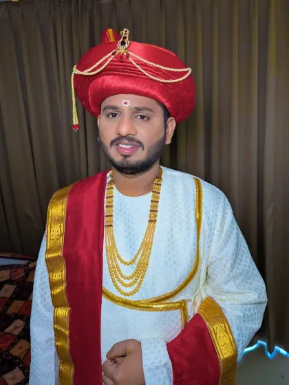 A happy Maharashtrian groom, ready for his wedding. The makeup is subtle, enhancing his features to match the grandeur of the Peshwai outfit.