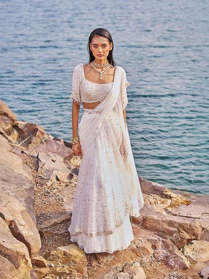 A stunning ivory sharara-saree, a perfect blend of traditional and contemporary styles for the modern woman.