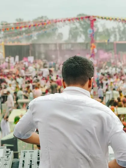Facing a sea of people at a Holi festival. This is the moment before the beat drops, a shared anticipation between me and thousands of partygoers.