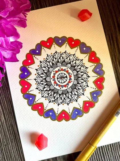 A celebration of love in all its colors. This mandala features a border of pink and purple hearts, with a detailed black and white center. It's a joyful piece that radiates warmth and affection.