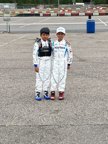 Two of our young drivers in their official Baby Race team gear, ready for their training sessions in Italy. This experience exposes them to the highest standards of international karting.