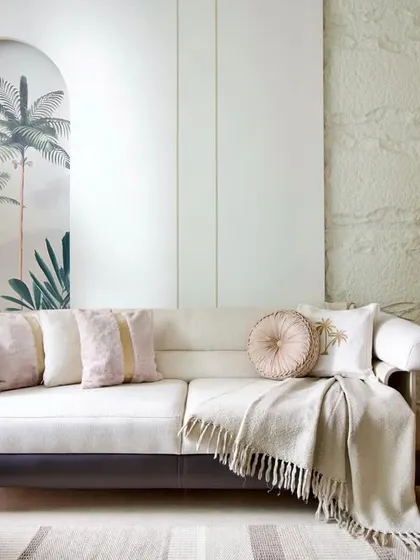 A detail from the 'House in the Hills' living room. The custom sofa and accent chair with its vibrant, earthy tones bring personality and warmth to the neutral space.