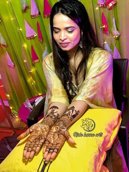 The happy bride with her completed figurative mehandi, a beautiful canvas of her wedding story.