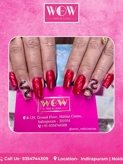 Make a bold statement with these long, square extensions in a glossy red. The accent nails feature an intricate, sparkling snake design, showcasing our skill in creating edgy and glamorous art.