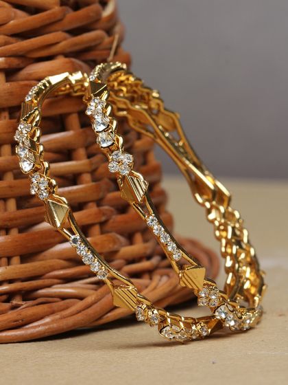A pair of sparkling, stone-studded gold-plated bangles.