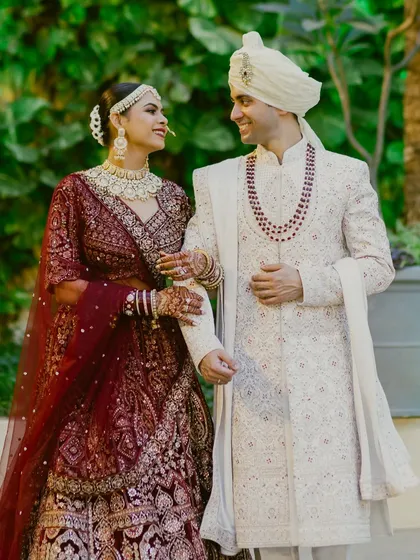 A happy couple, ready to start their new life together. The bride's makeup is soft and romantic, perfectly complementing her groom's classic sherwani.