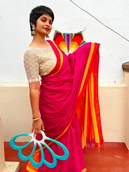 Blending the elegance of a saree with the movement of my fans feels so natural. It shows that flow is a part of who I am. This art isn't separate from life; it weaves into it, adding color and grace to the everyday.