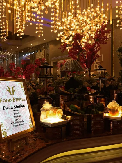 My dedicated Pasta Station, beautifully decorated and lit, with a menu offering penne, fusilli, and spaghetti with a choice of tomato basil or cream sauce. It's an Italian food lover's dream.