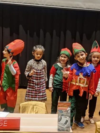 Our little elves from 'The Elves and the Shoemaker' ready for their scene. The colorful costumes help children get into character and add visual appeal to the show.
