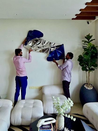 The team installing a silver and blue Meteor piece in a client's home, designed in collaboration with MJ Architects.