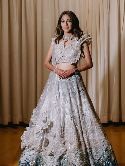 A full-length portrait of Ria in her stunning Sangeet lehenga.
