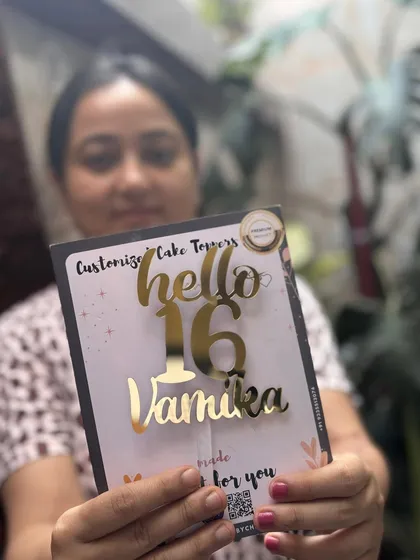 Turning sixteen is a big deal, and this "Hello 16 Vamika" topper is the perfect way to mark the occasion. The combination of script and block fonts gives it a trendy, youthful vibe.