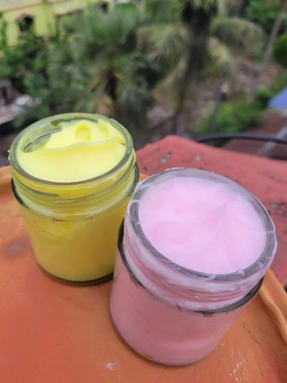A side-by-side view of my yellow Fresh Lime and pink Cherry Blossom body yogurts. The colors are as delightful as their fragrances and benefits for your skin.