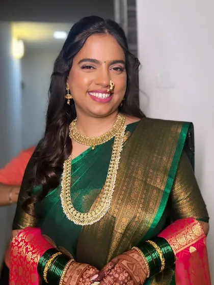 An engagement look featuring a beautiful green Kanjivaram saree. The makeup is kept soft and glowing to let the rich saree and gold jewelry stand out.