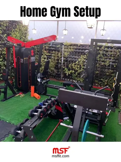 Another angle of a comprehensive home gym installation. This setup includes a functional trainer, leg press, and dumbbell rack, providing a full-body workout solution at home.