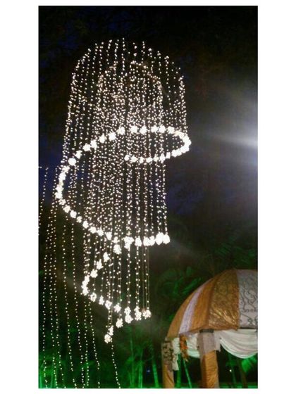 Lighting is crucial for setting the mood. This spiral chandelier made of fairy lights is a stunning centerpiece we created for an evening event, adding a touch of magic and wonder to the decor.